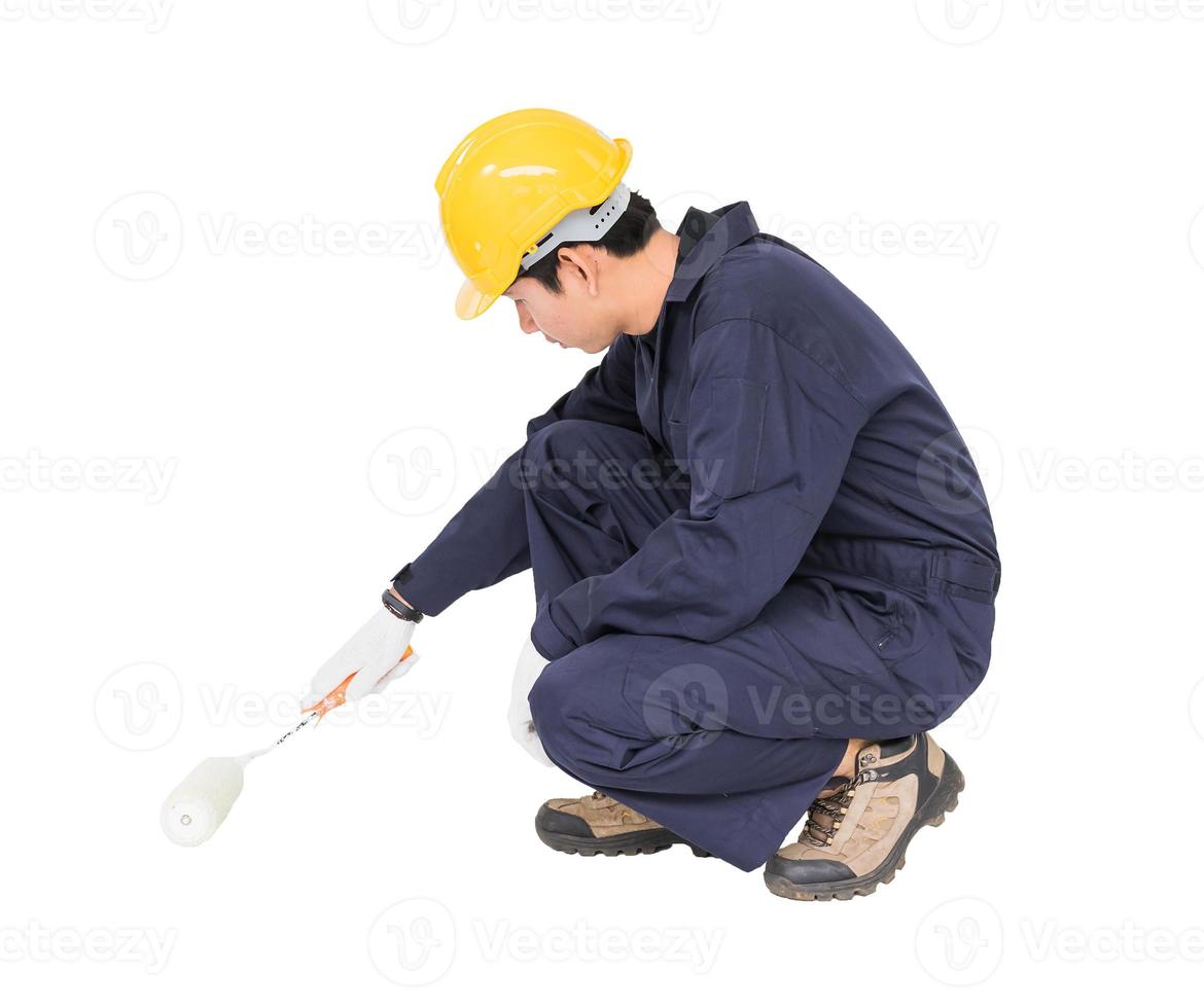 Worker in a uniform using a paint roller is painting invisible floor photo