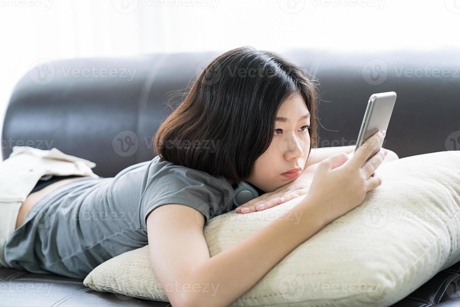 Young woman listening music from mobile phone photo