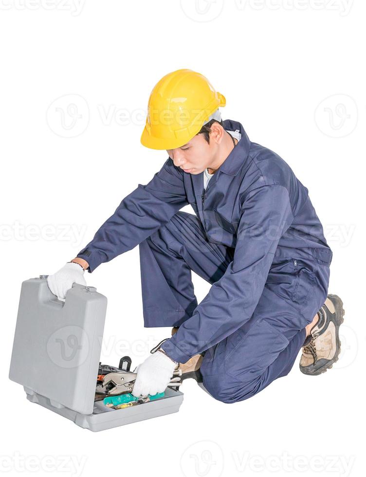 Young handyman sitting with his tool box photo