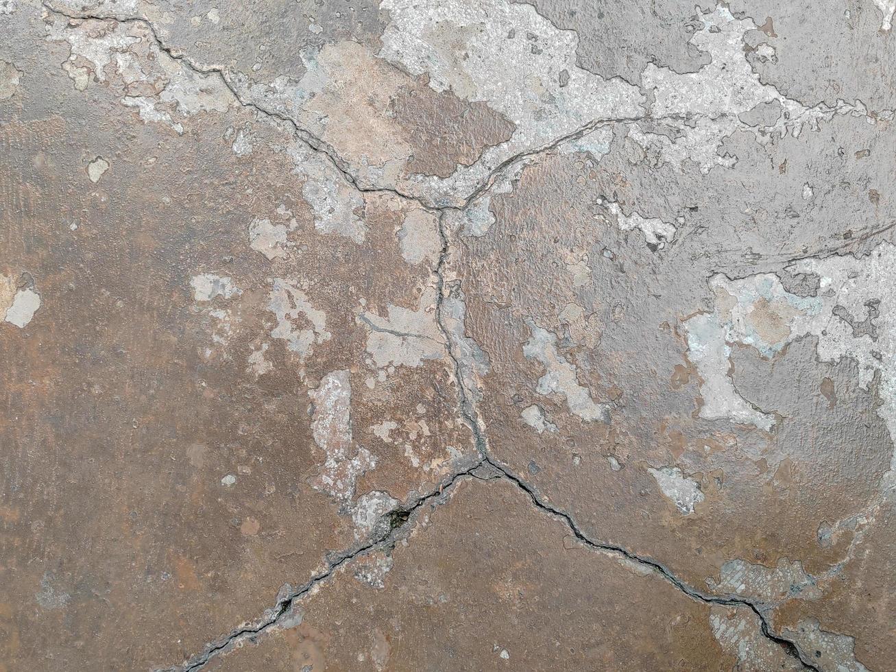 Cracked concrete ground broken at floor or street road from earthquake photo