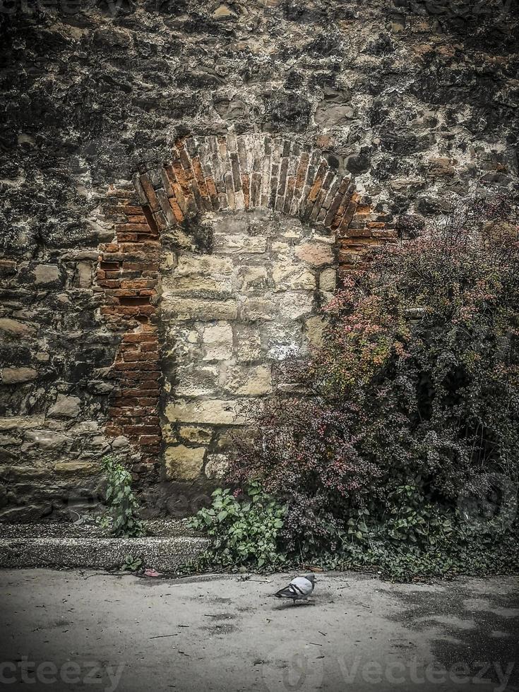 An old rustic wall with arc-shaped bricks in Zagreb in the autumn photo