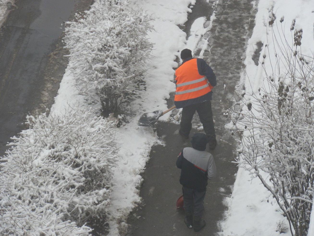 Cleaning the street with snow wipers in winter photo
