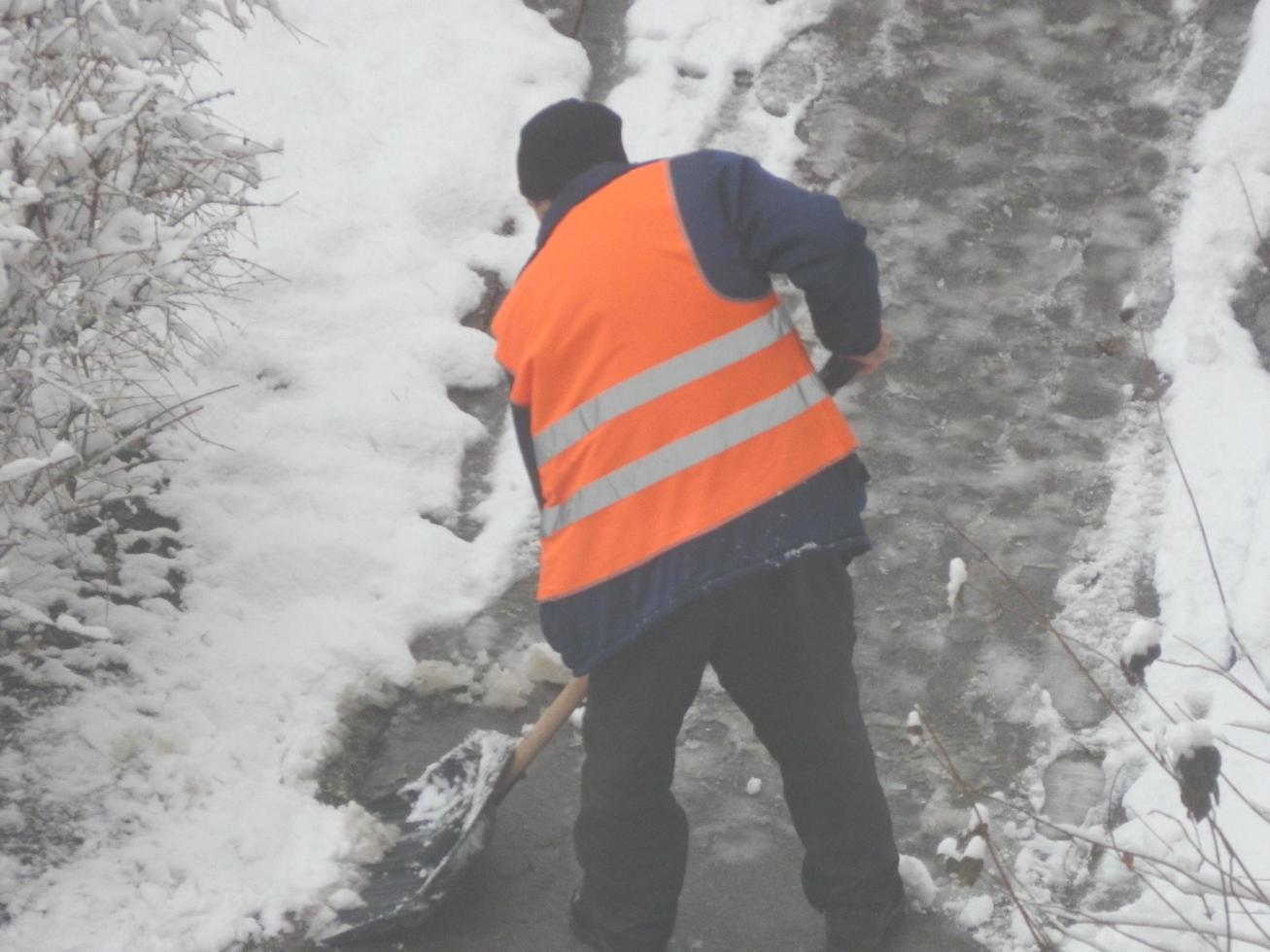 Cleaning the street with snow wipers in winter photo