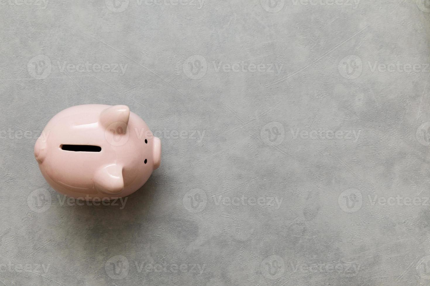 Simply minimal design piggy bank on concrete stone grey background. Saving investment budget wealth business retirement financial money banking concept. Flat lay top view copy space banner. photo