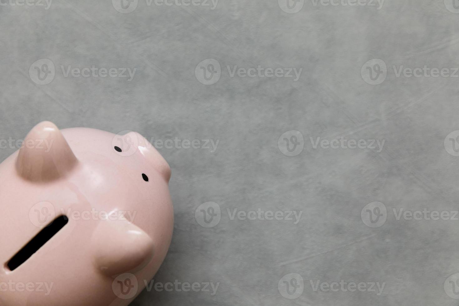 Simply minimal design piggy bank on concrete stone grey background. Saving investment budget wealth business retirement financial money banking concept. Flat lay top view copy space banner. photo