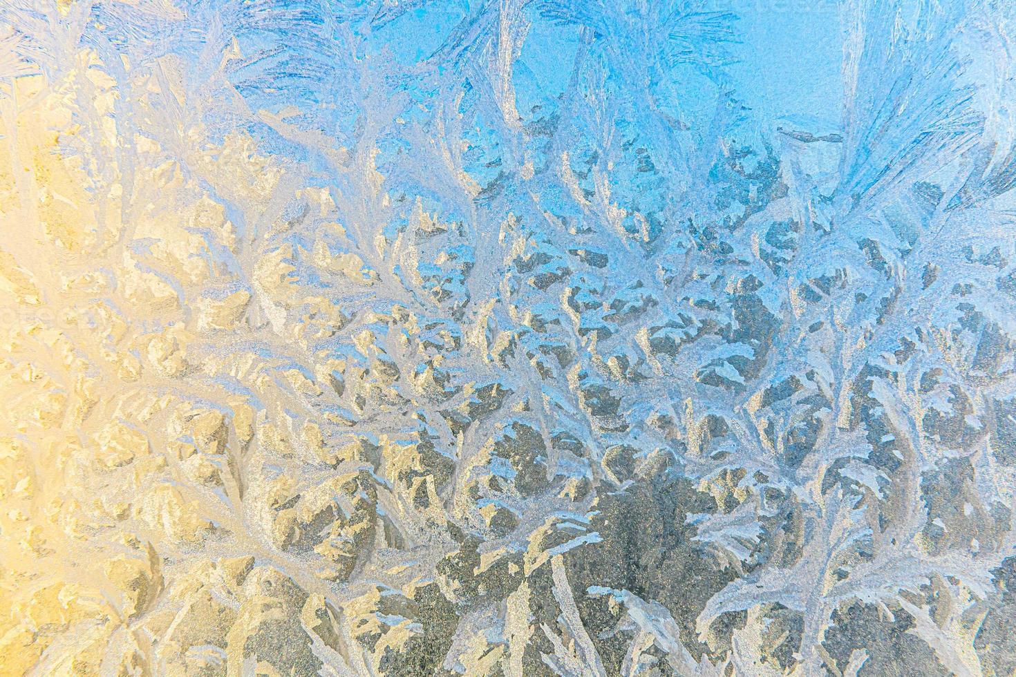 Frozen winter window with shiny ice frost pattern texture. Christmas wonder symbol, abstract background. Extreme north low temperature, natural Ice snow on frosty glass, cool winter weather outdoor. photo