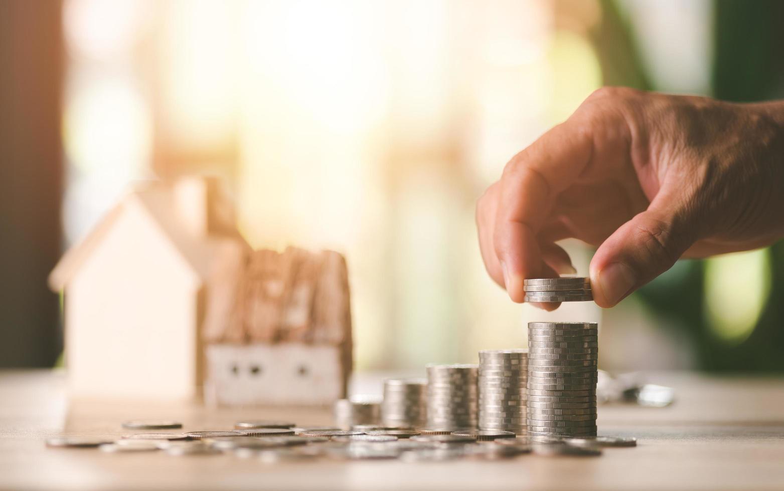 Male hands stacking coins,investment loan concepts to build a residential home,real estate business,investment savings,mortgage and bank loans,future retirement planning photo