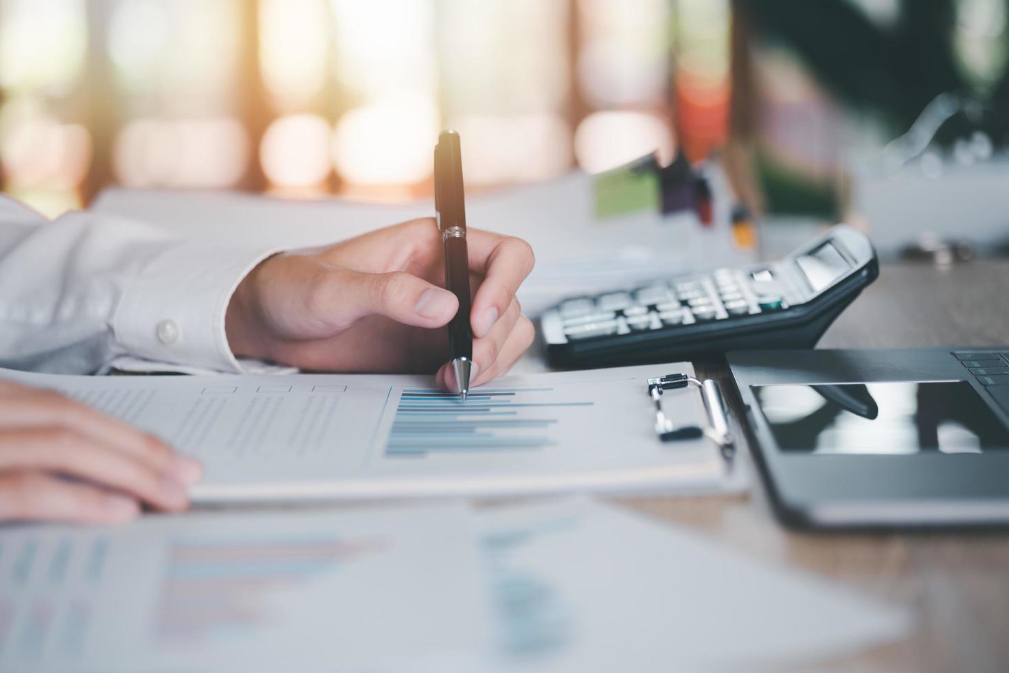 Business people read business statistics chart reports, to analyze and improve corporate strategy, manage financial and marketing documents, update annual budget accounts, company growth data. photo