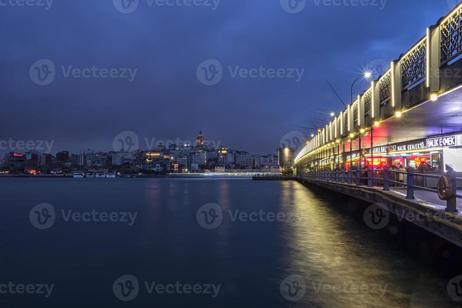 Istanbul, Turkey - March 23, 2018. night illuminated Galata Bridge. It is one of the main attractions of Istanbul. photo