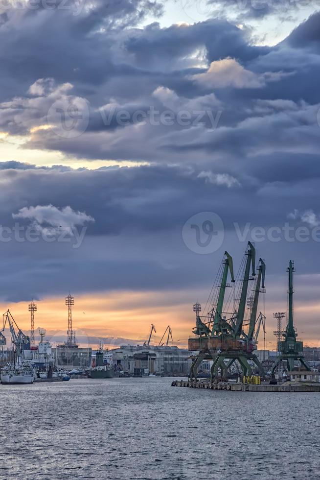 In the evening, the part of port with cranes.Ready to load containers from cargo ships. photo