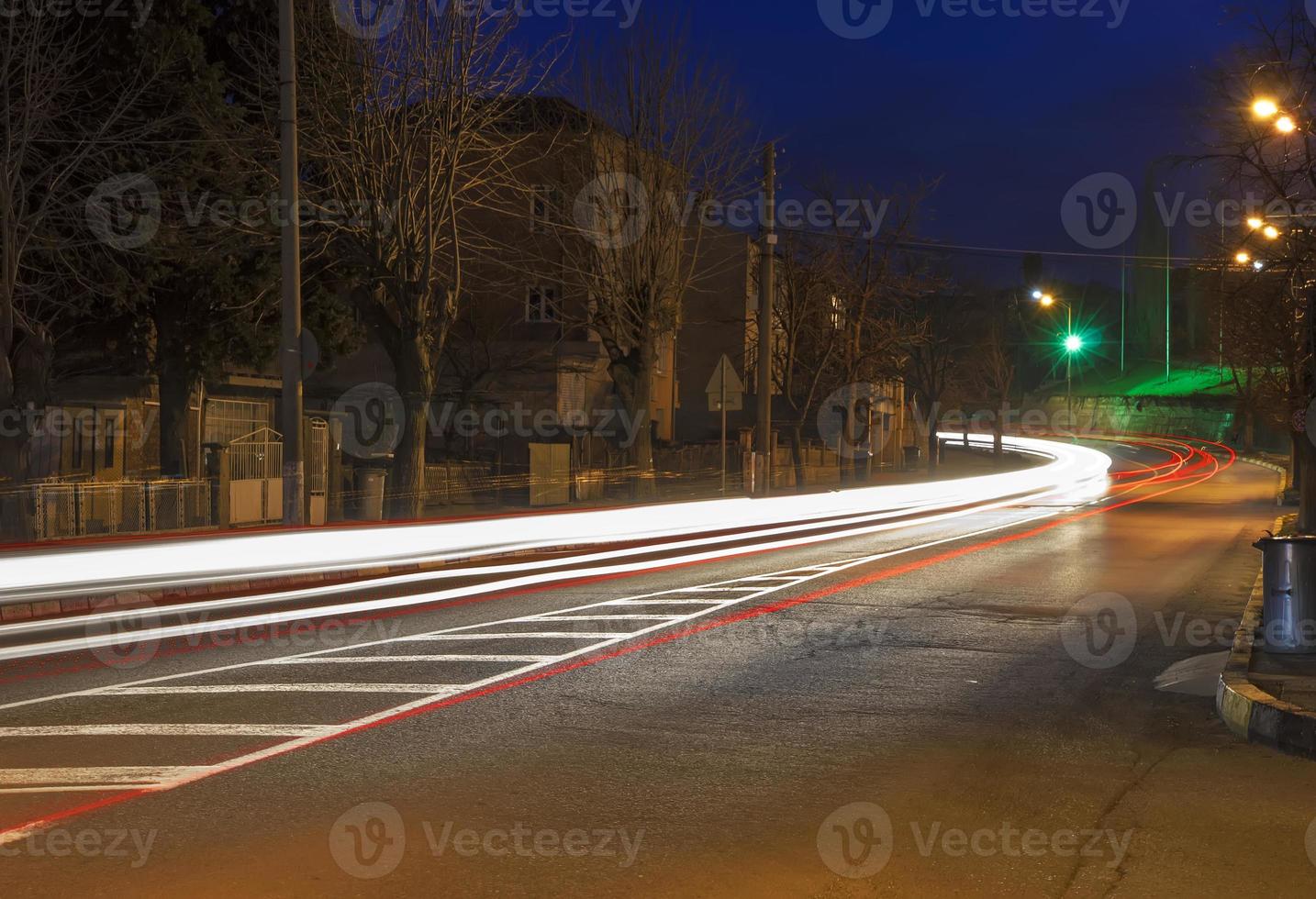 Car light traces from moving a vehicle at dusk in the city photo