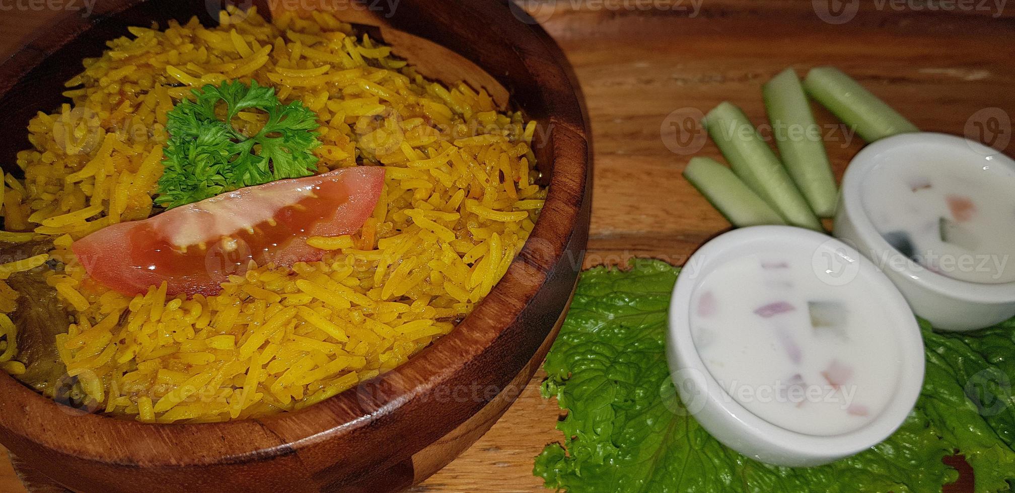 Rice lamb biryani pilaf with lamb meat and vegetables cucumber along