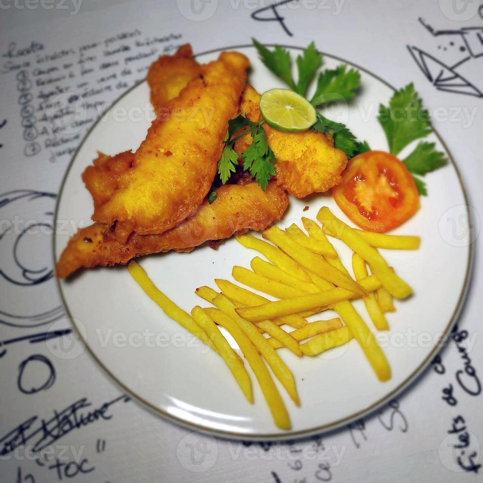 fish and chips meal breaded cod fish fillet with French fries served on plate photo
