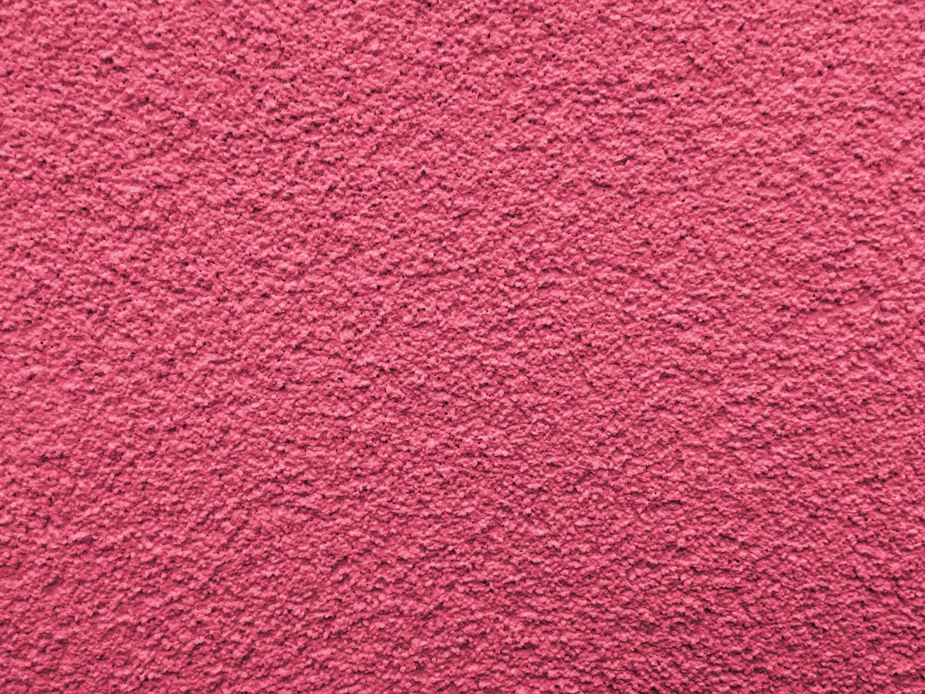 Textured surface of the wall. Viva Magenta, Pantone Color of the year 2023 photo