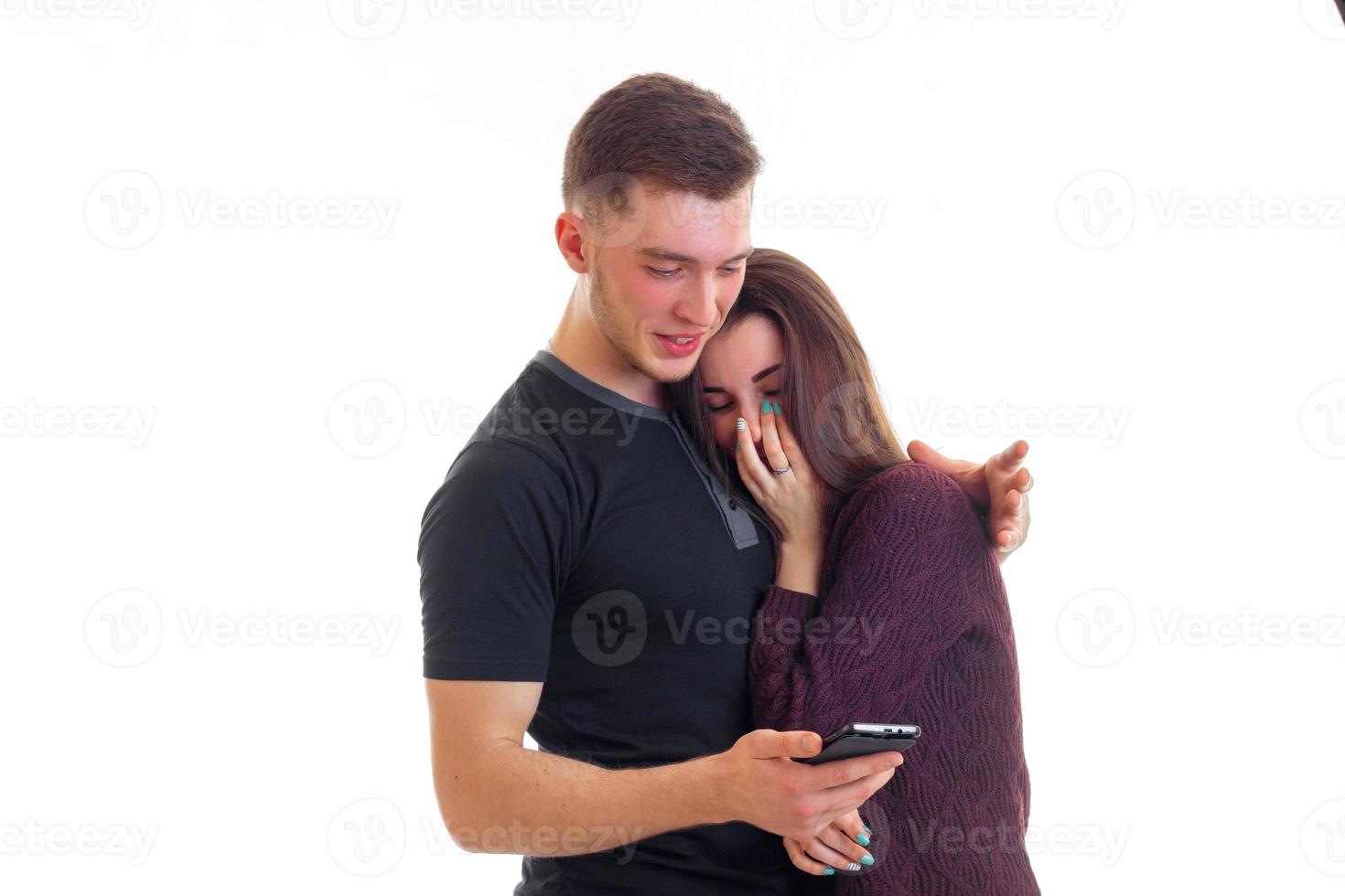 handsome guy with his cute girl watching and laughing phone photo