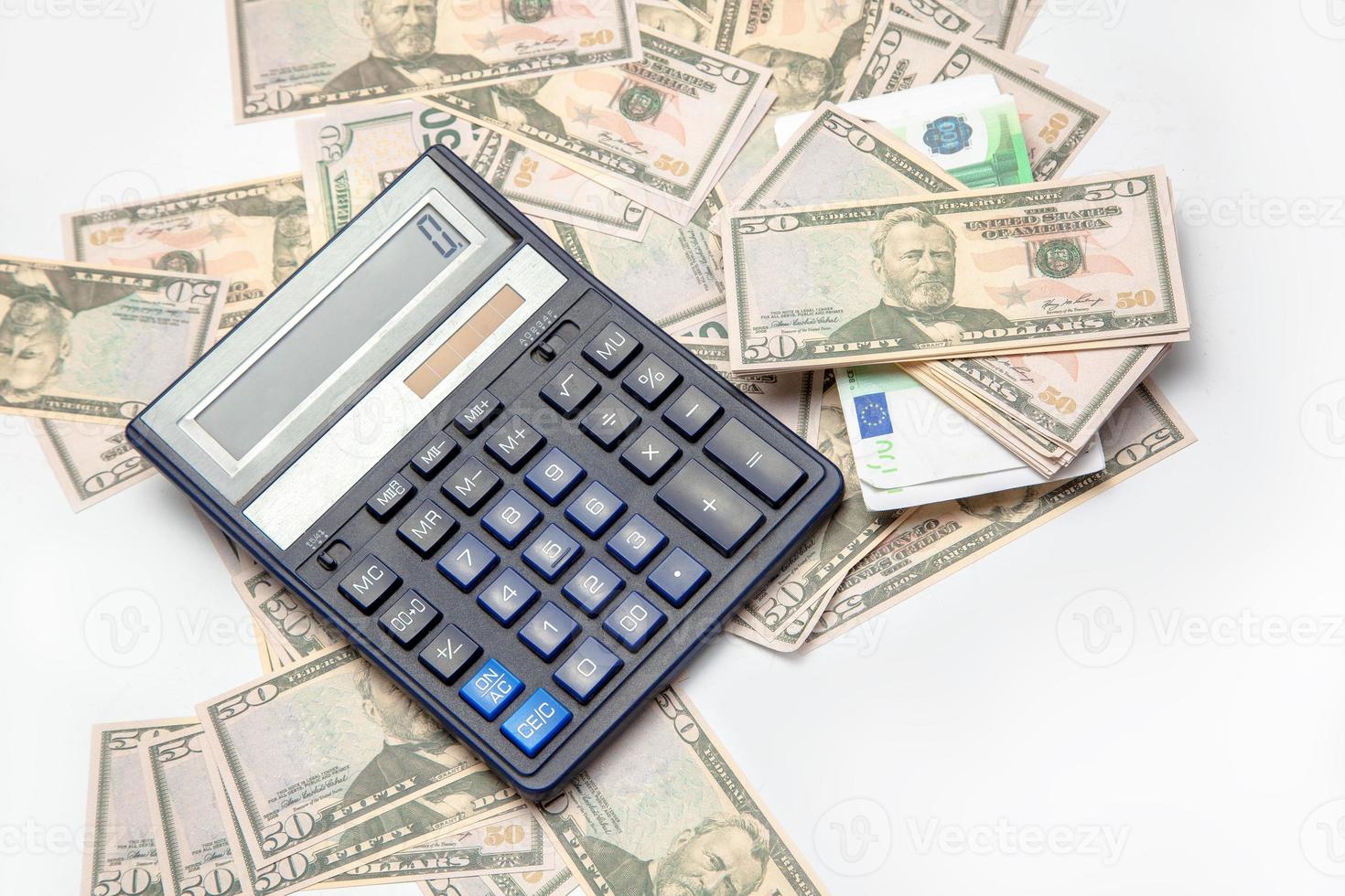 money and the calculator on a table photo