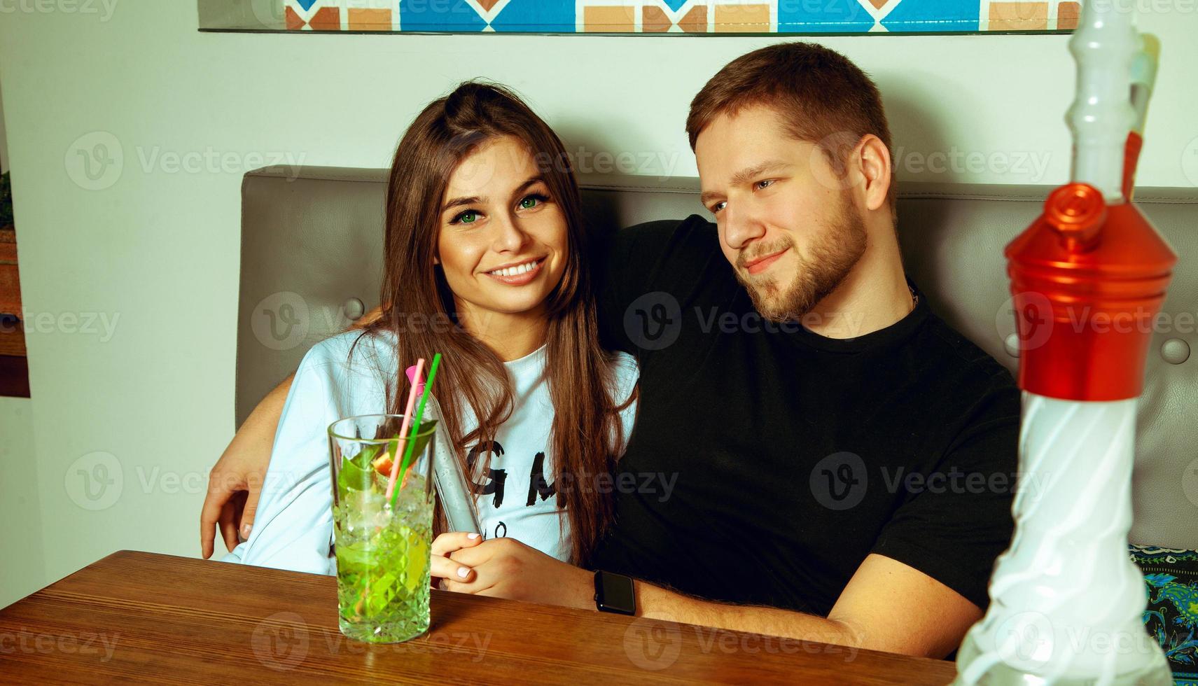 couple at the hookah bar posing and smiling photo