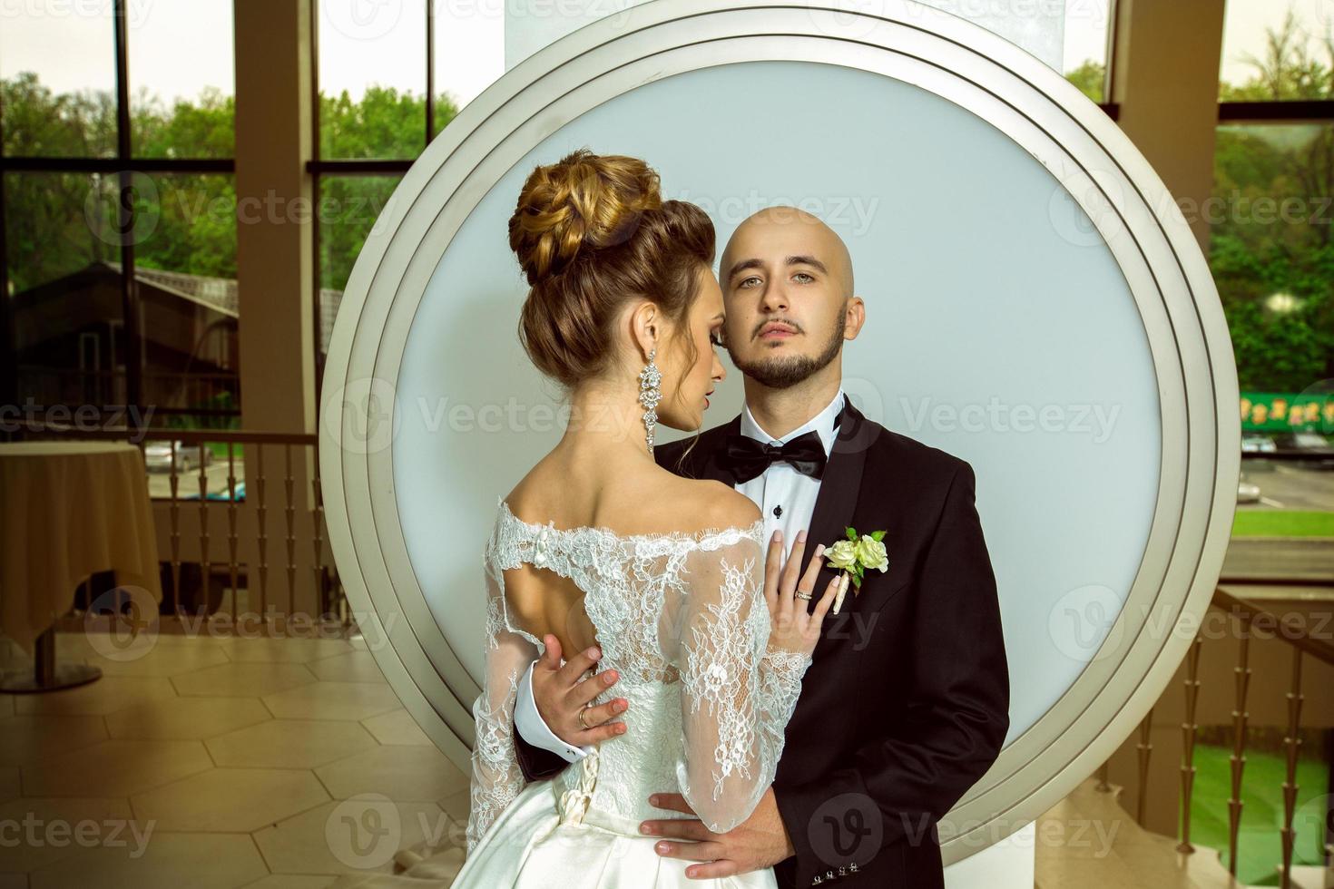 portrait of beautiful married couple hugging photo