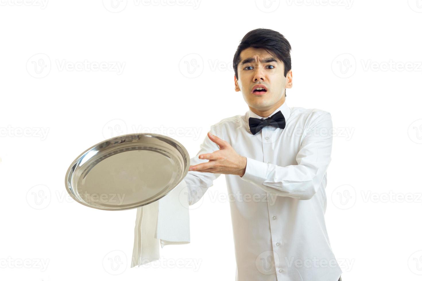 young guy waiter throws forward ware tray photo