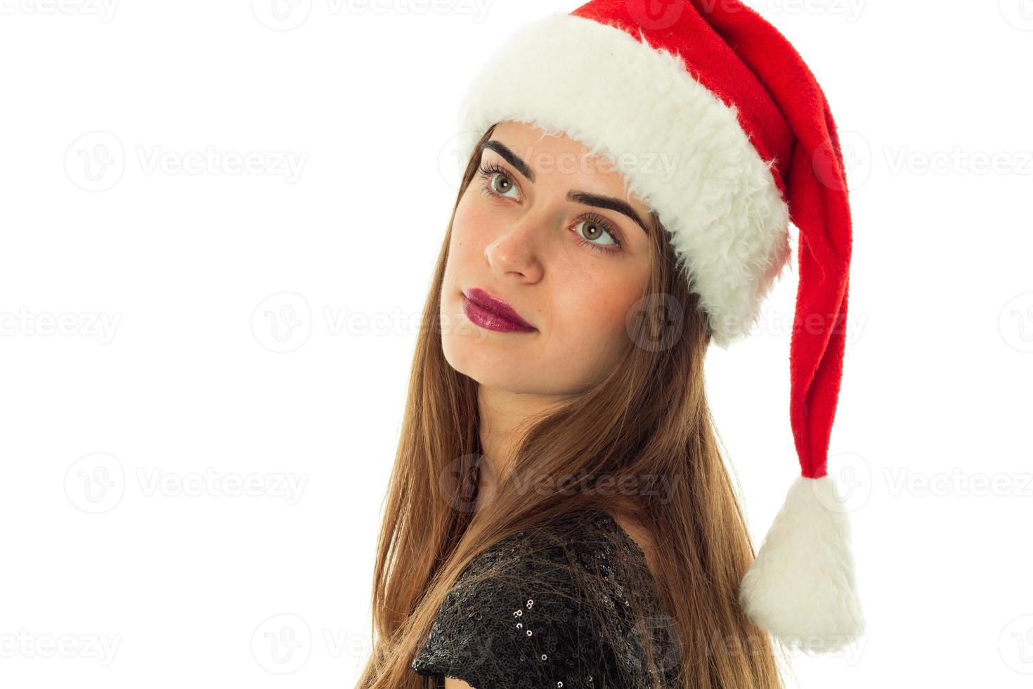 portrait of happy attractive woman in santa hat photo