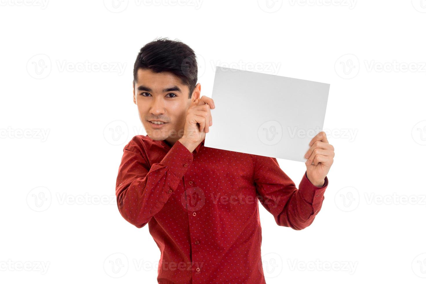 young brunette man in red t-shirt posing with white placard isolate on  background photo