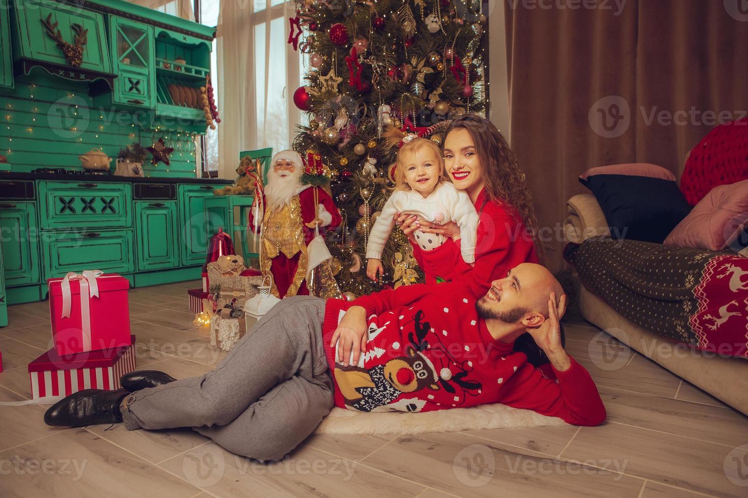 horizontal photo of beautiful family with daughter celebrate New year and Christmas together at home