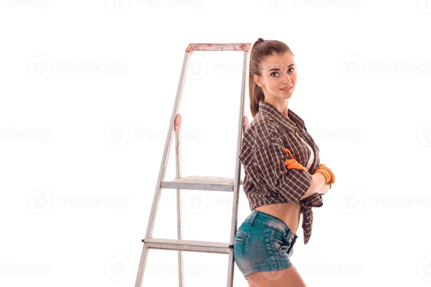 sexy young girl in uniform makes renovation isolated on white background photo