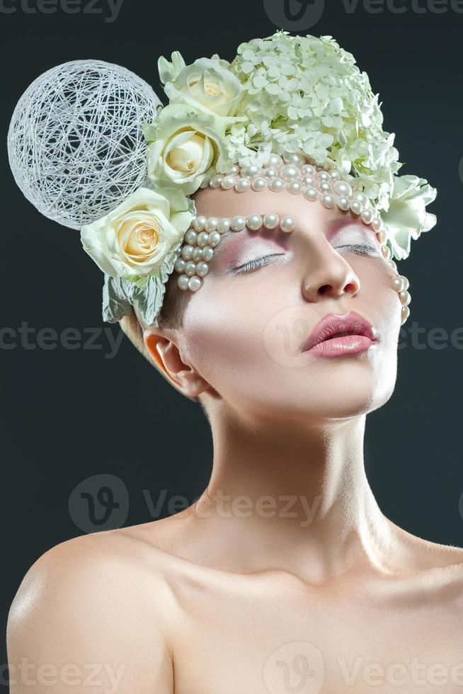 Attractive adult woman with tender makeup and creative accessories on head photo