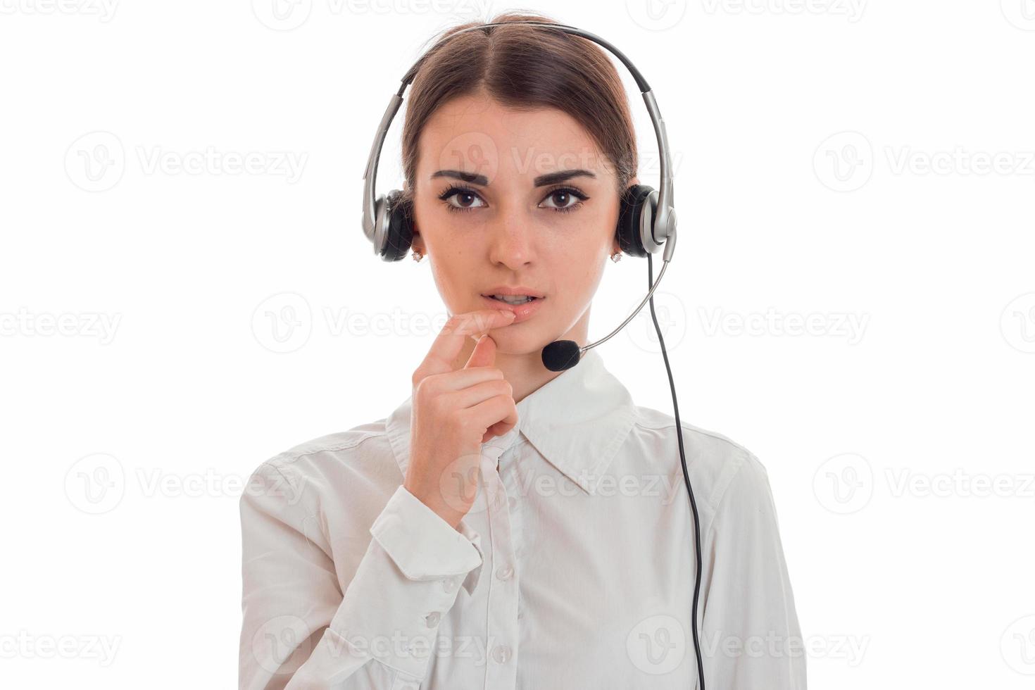 portrait of young beauty call center worker girl with headphones and microphone posing isolated on white background photo