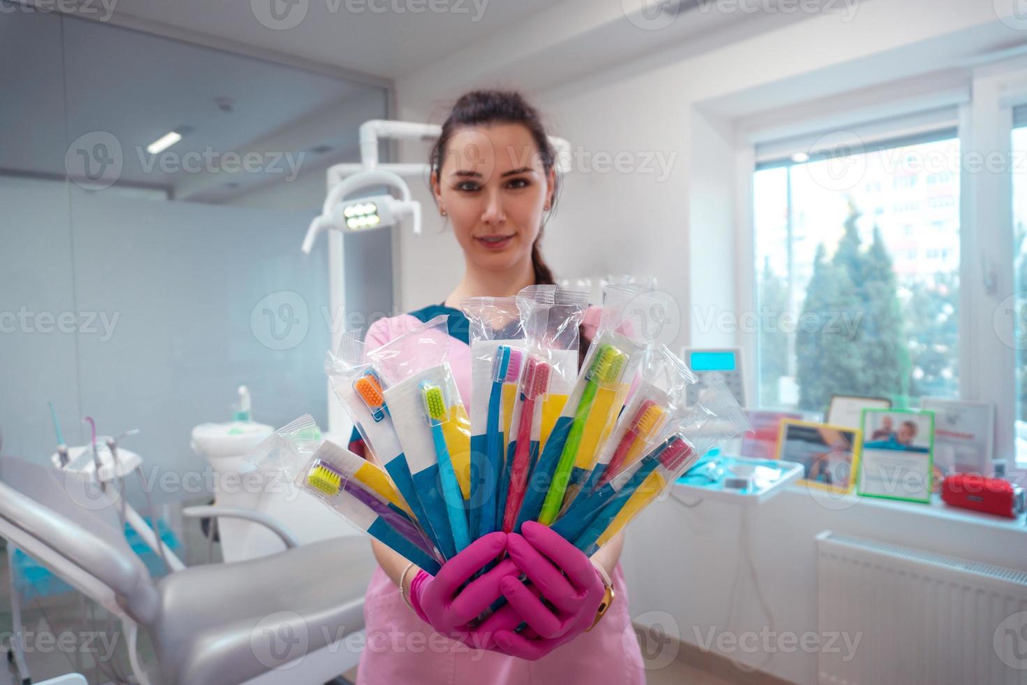 set of toothbrushes in the hands of the dentist photo