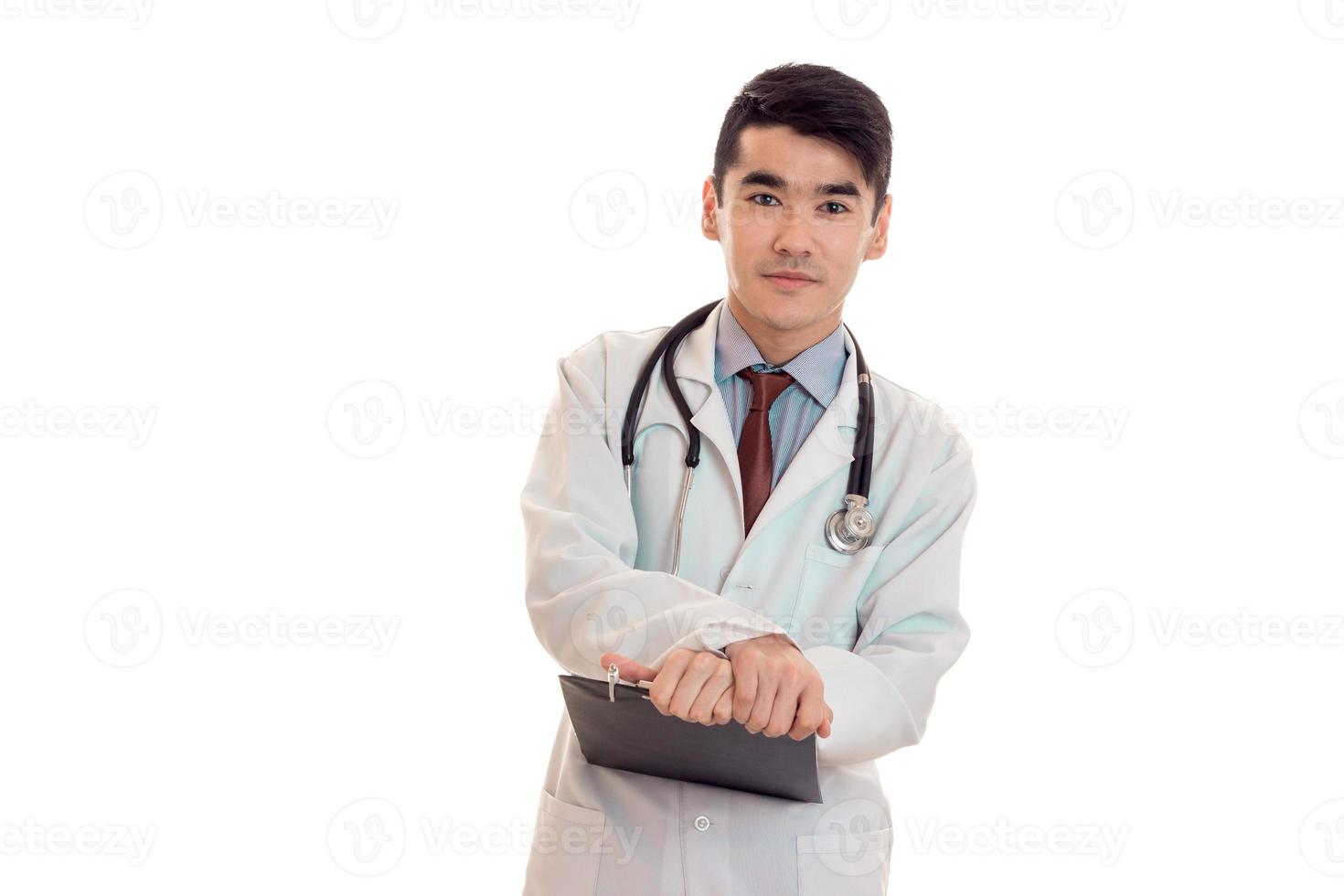 studio portrait of serious male doctor in uniform posing isolated on white background photo