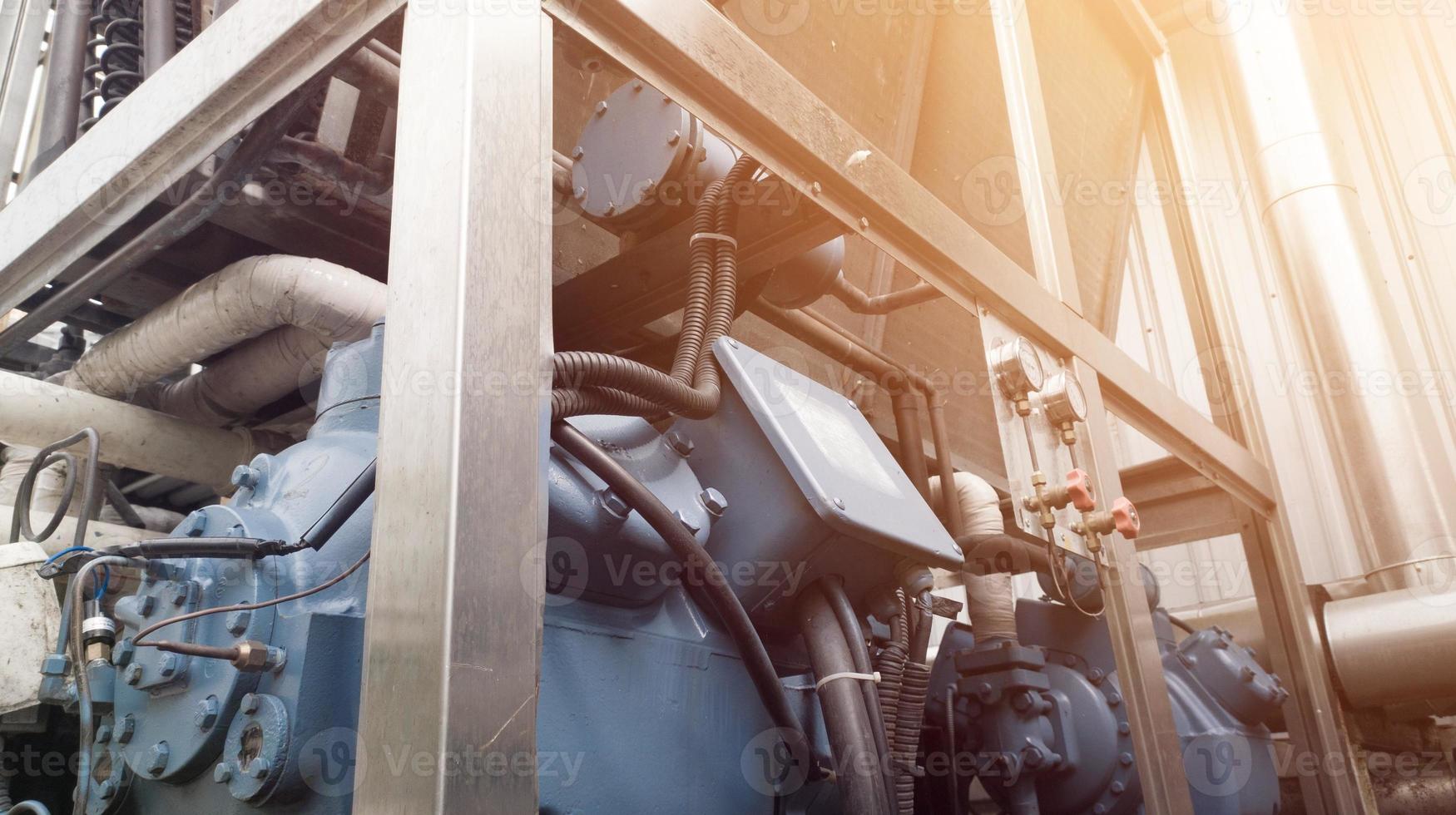 Industrial Chiller Machine in factory,  Compressor chiller operation.with shiny light. photo