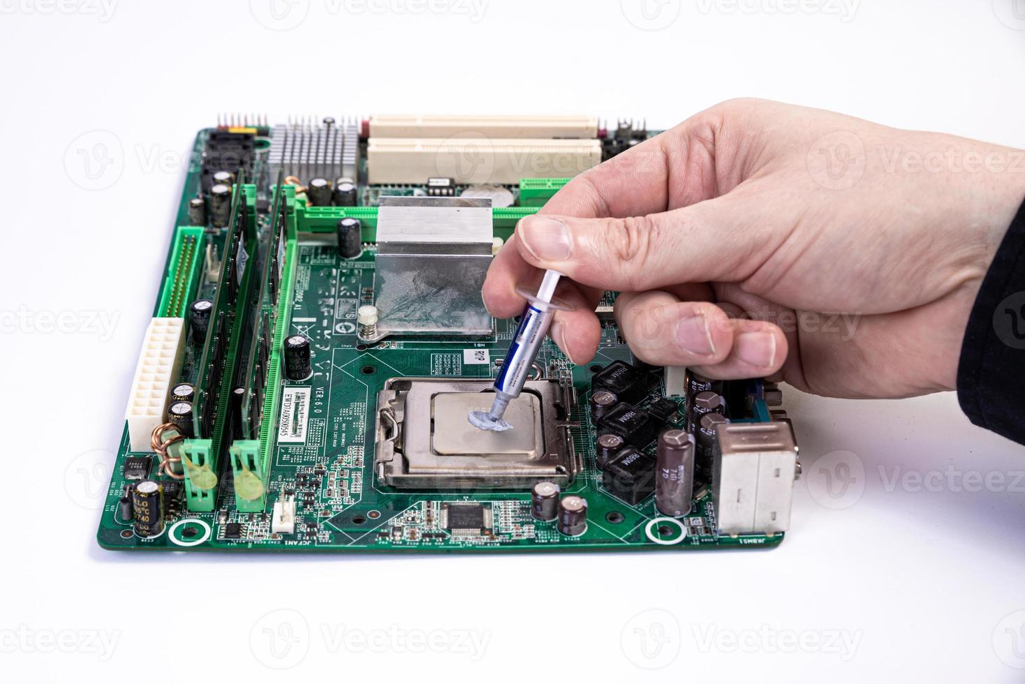 Engineer repairman holding hands in black gloves chip processor, CPU to insert into the socket of the computer motherboard. The concept of technology hardware in the neon light photo