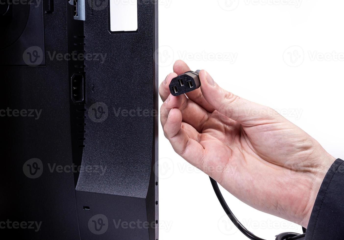 IT engineer Man hand inserts cable into monitor. Man hand connecting the DVI cable for monitor to computer PC. VGA DVI DisplayPort and power cable. close up in the hands of an . isolated photo