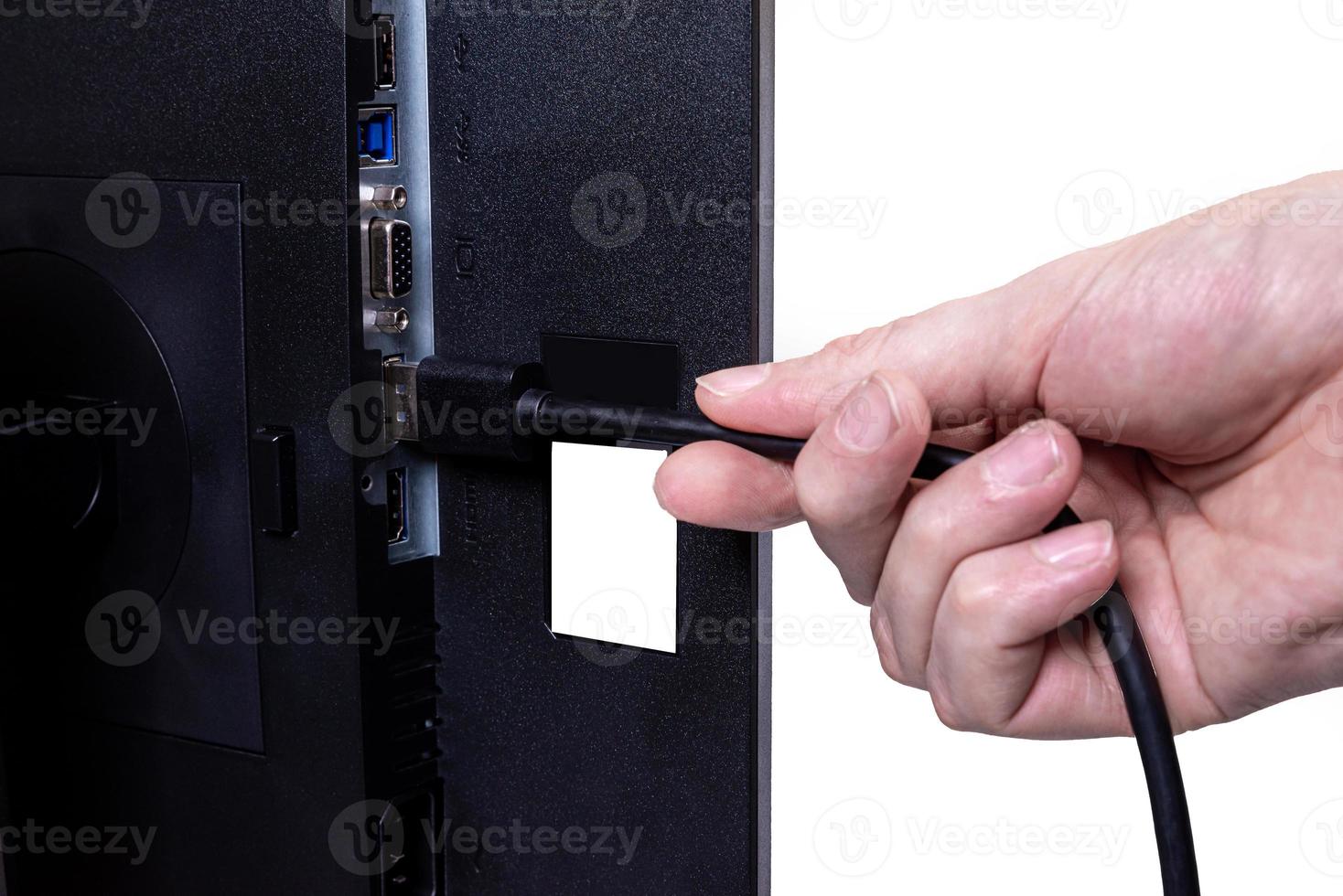 IT engineer Man hand inserts cable into monitor. Man hand connecting the DVI cable for monitor to computer PC. VGA DVI DisplayPort and power cable. close up in the hands of an . isolated photo