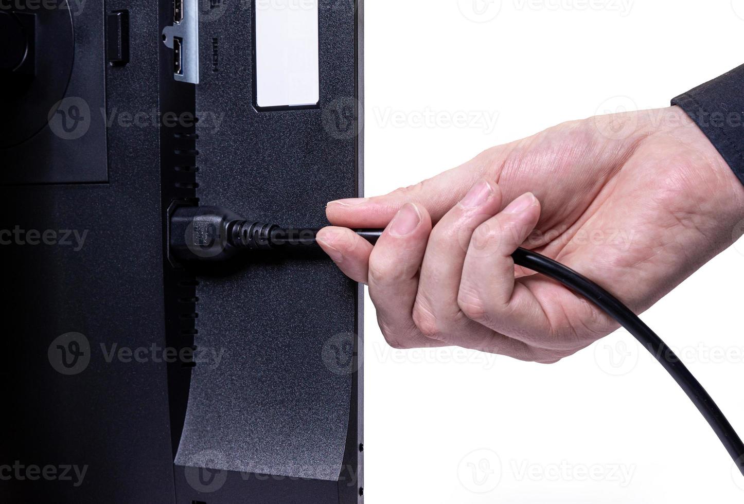 IT engineer Man hand inserts cable into monitor. Man hand connecting the DVI cable for monitor to computer PC. VGA DVI DisplayPort and power cable. close up in the hands of an . isolated photo