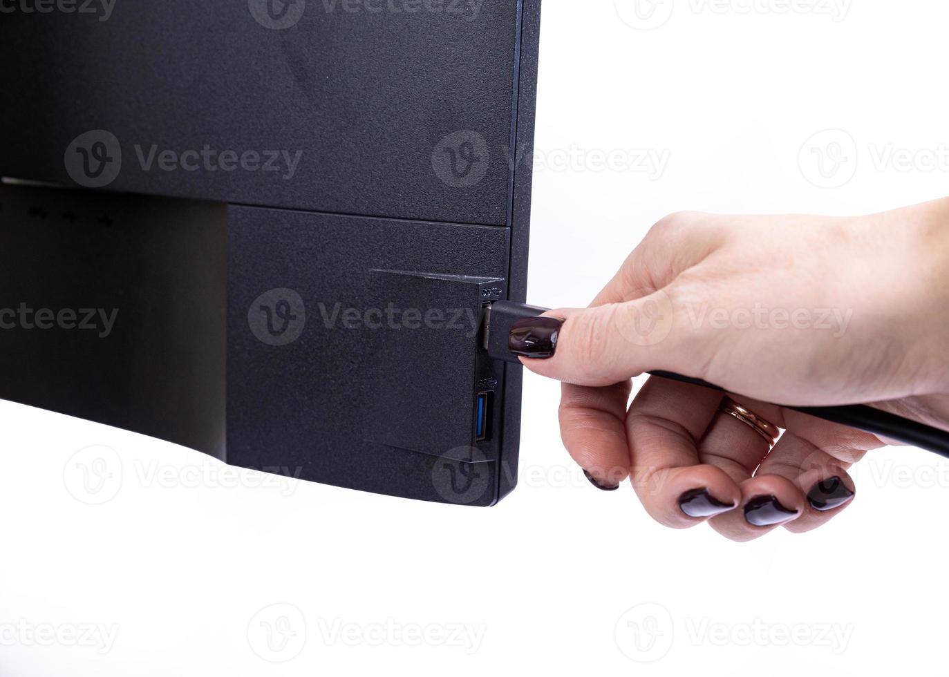 IT engineer Man hand inserts cable into monitor. Man hand connecting the DVI cable for monitor to computer PC. VGA DVI DisplayPort and power cable. close up in the hands of an . isolated photo