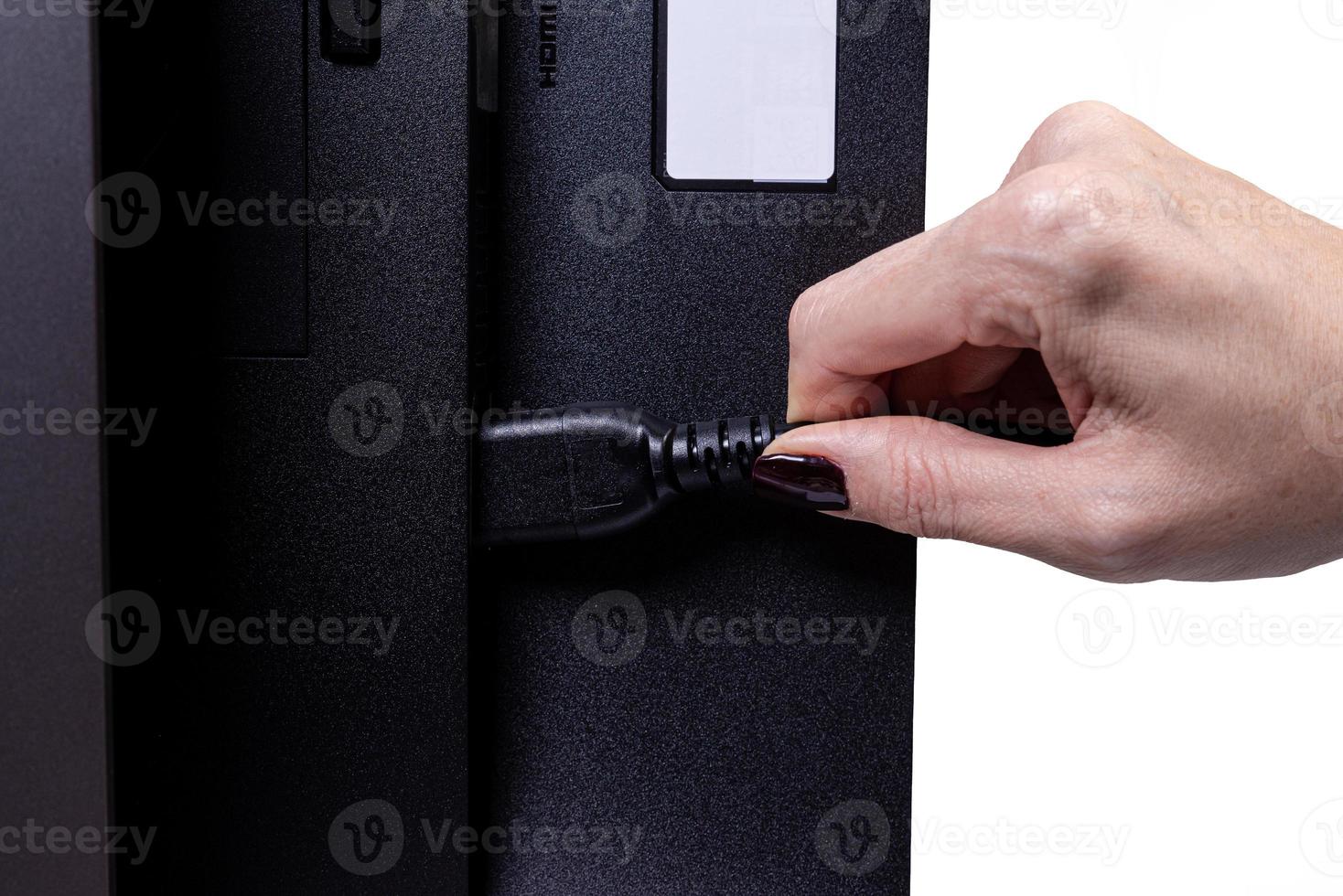 IT engineer Man hand inserts cable into monitor. Man hand connecting the DVI cable for monitor to computer PC. VGA DVI DisplayPort and power cable. close up in the hands of an . isolated photo