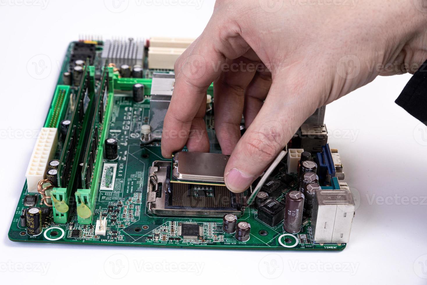 Engineer repairman holding hands in black gloves chip processor, CPU to insert into the socket of the computer motherboard. The concept of technology hardware in the neon light photo