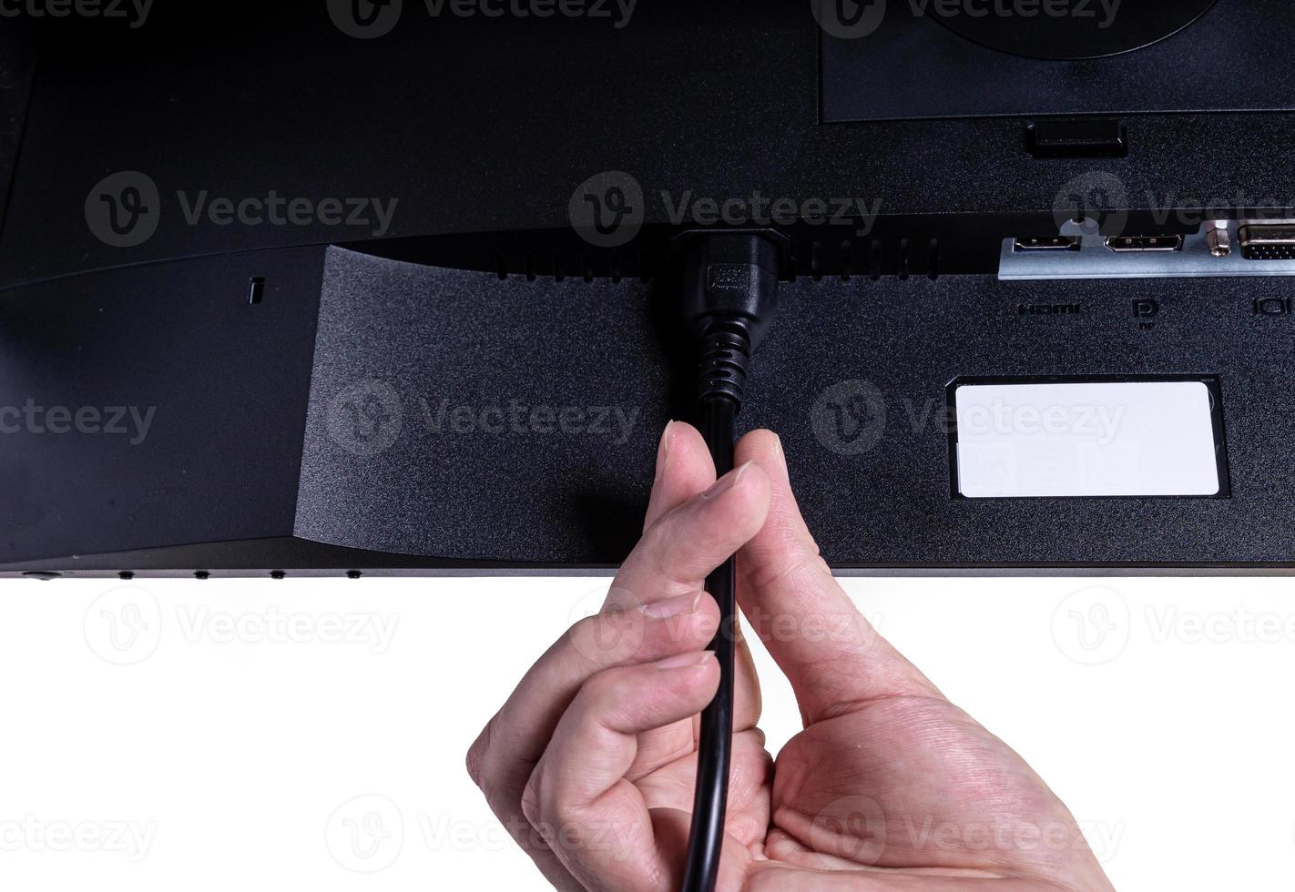 IT engineer Man hand inserts cable into monitor. Man hand connecting the DVI cable for monitor to computer PC. VGA DVI DisplayPort and power cable. close up in the hands of an . isolated photo