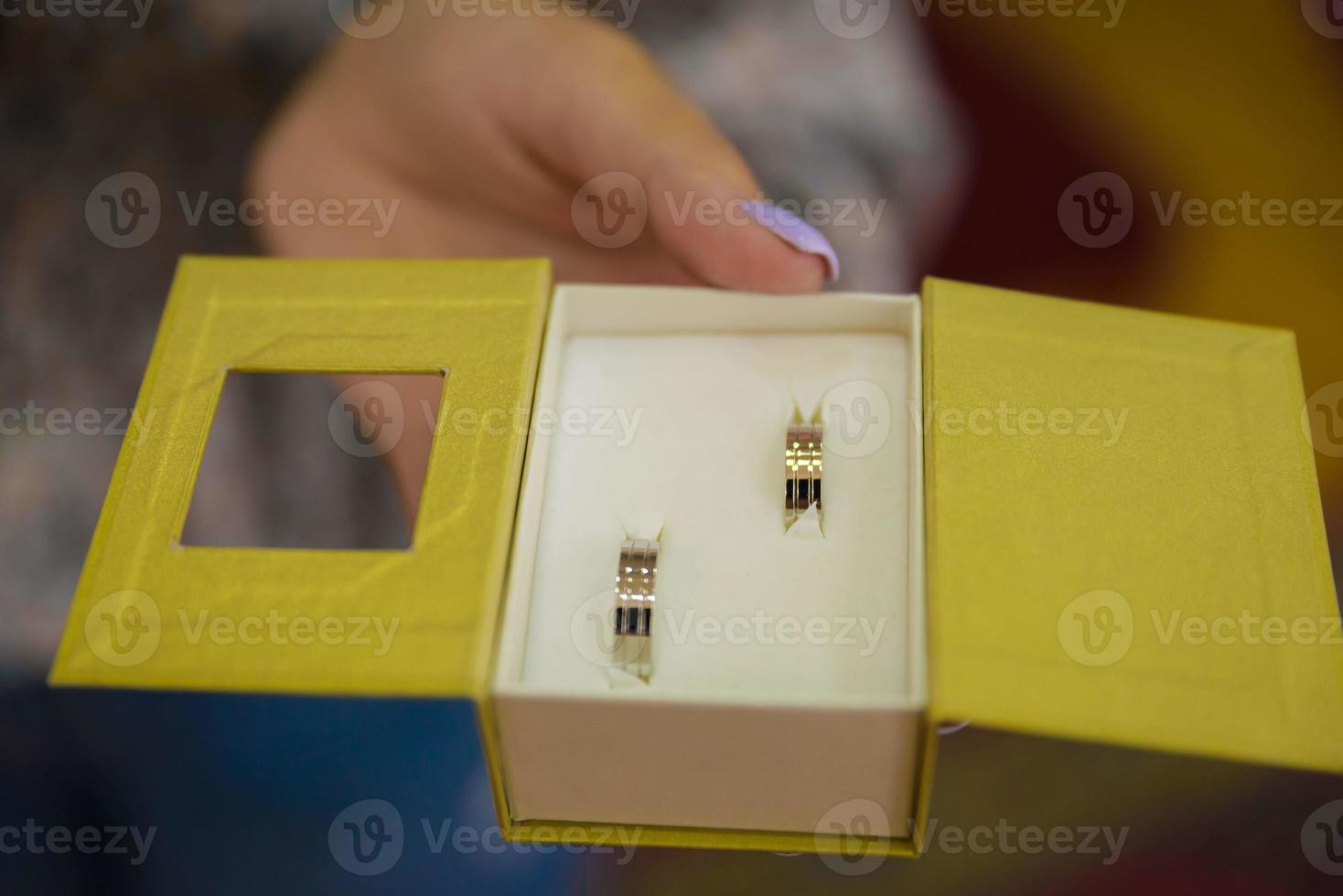 wedding rings in hand. Two wedding rings on the floor with contrast wedding rings on floor, on ground, on piano, in hand on grass or a stones, photo