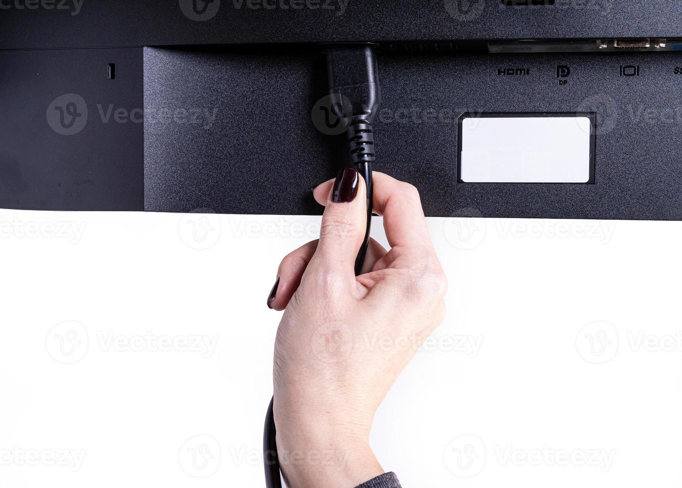 IT engineer Man hand inserts cable into monitor. Man hand connecting the DVI cable for monitor to computer PC. VGA DVI DisplayPort and power cable. close up in the hands of an . isolated photo