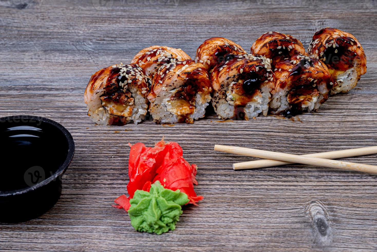 Traditional delicious fresh sushi roll set on a black background with reflection. Sushi roll with rice, cream cheese, avocado, salmon, sesame. Philadelphia. Sushi menu. Japanese kitchen, photo
