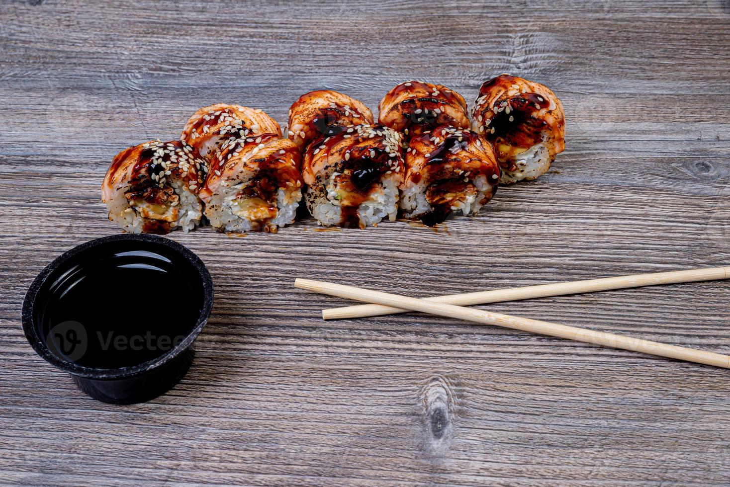 Traditional delicious fresh sushi roll set on a black background with reflection. Sushi roll with rice, cream cheese, avocado, salmon, sesame. Philadelphia. Sushi menu. Japanese kitchen, photo