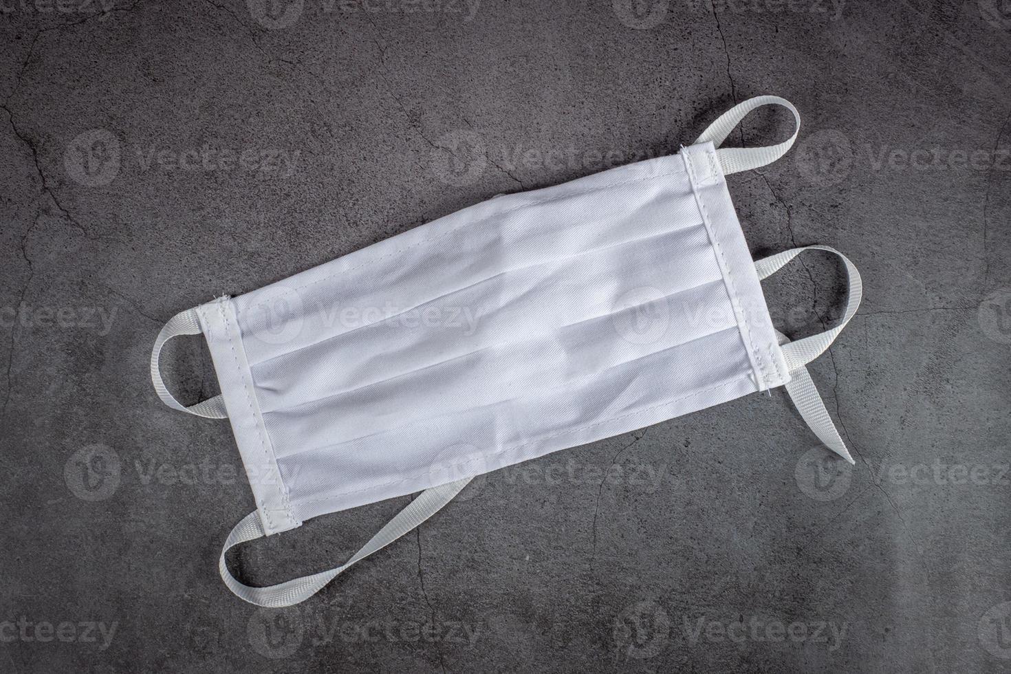 Protective medical mask on black background. Mask protection against pollution, virus, flu and coronavirus, covid 19. photo