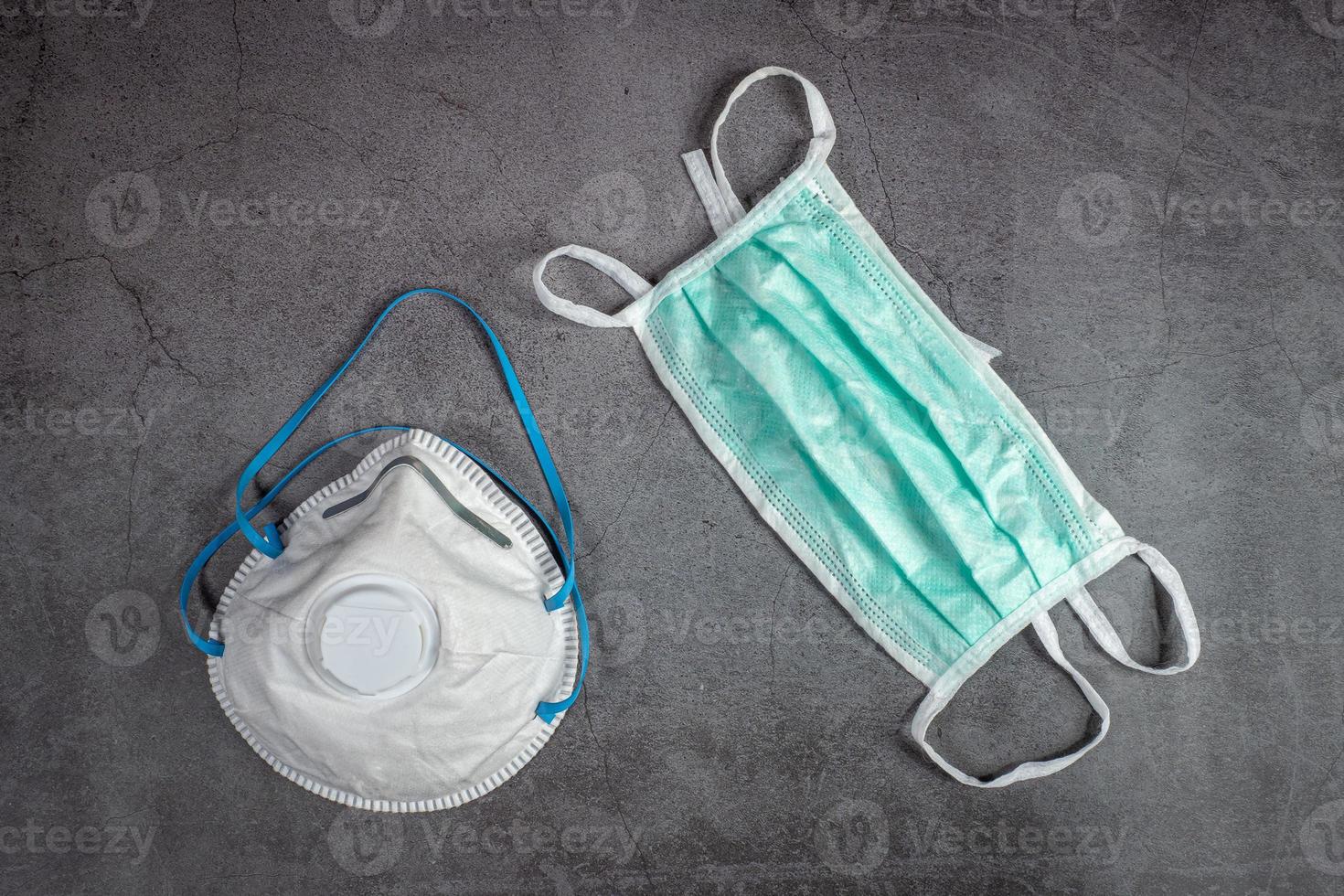 Protective medical masks and respirator masks FFP2 on black background. Mask protection against pollution, virus, flu and coronavirus 2019-nCoV. photo