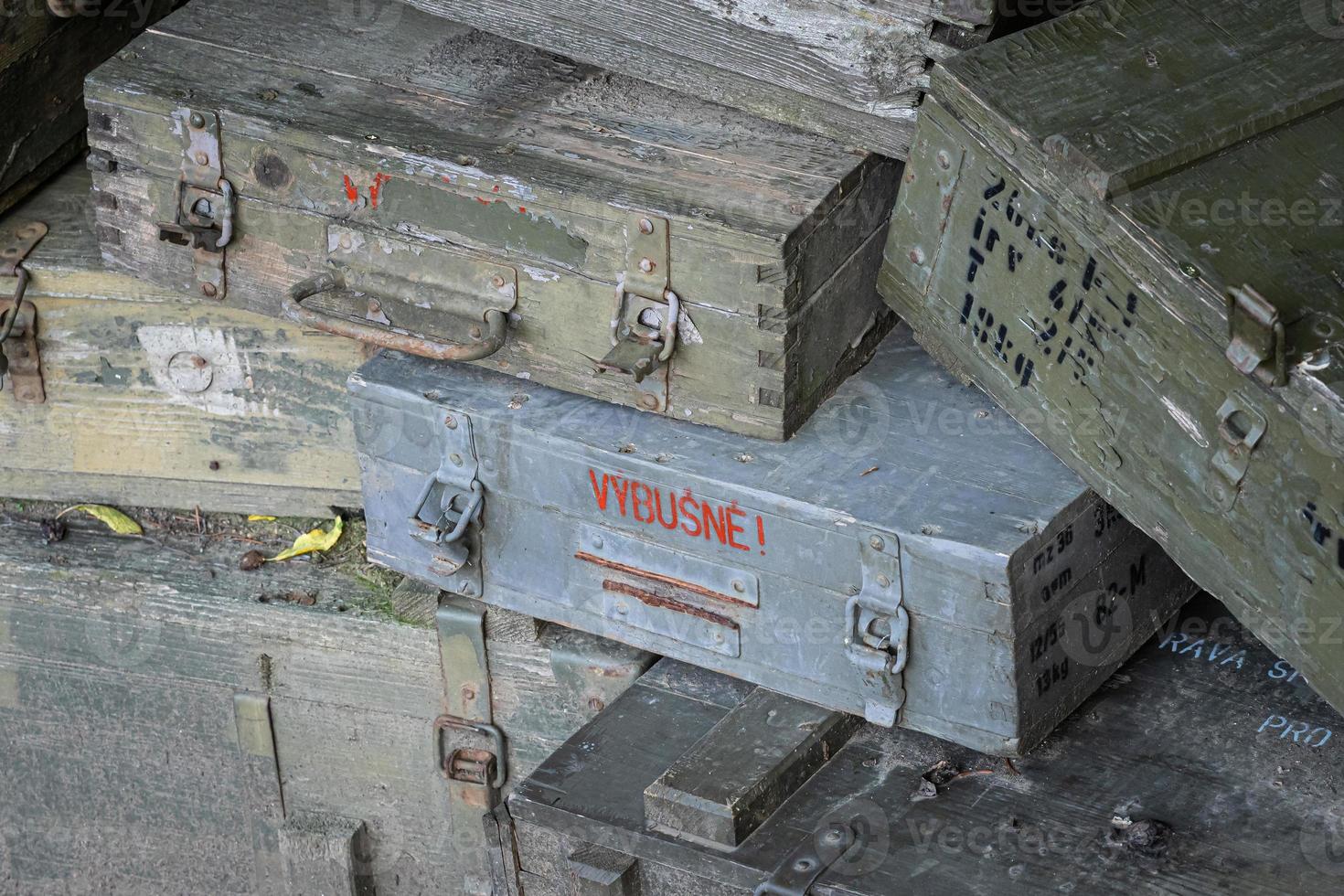 A stack of old wooden military green boxes with ammunition. photo