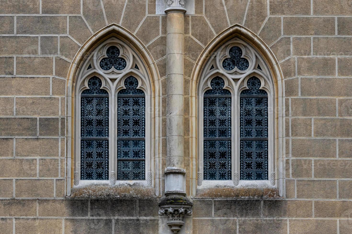Gothic medieval stained glass window and stone arch.  Architectural element. photo