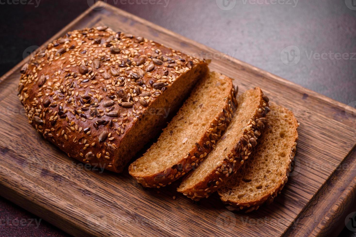 Delicious crispy bread with cereals on a wooden cutting board photo