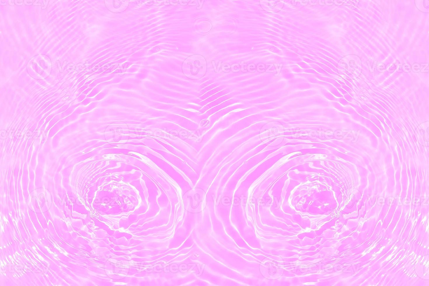 Defocus blurred transparent purple colored clear calm water surface texture with splashes and bubbles. Trendy abstract nature background. Water waves in sunlight with copy space. Pink water drop shine photo